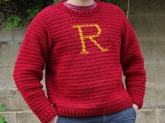 a man wearing a red knitted sweater with the letter r in yellow on it