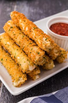 fried chicken sticks on a plate with dipping sauce