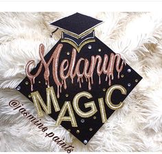 a graduation cap with the words melpan magic painted on it in gold and black