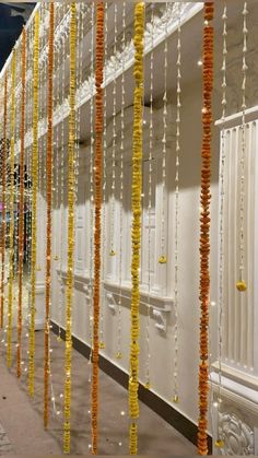 several rows of white and yellow garlands hanging from the ceiling