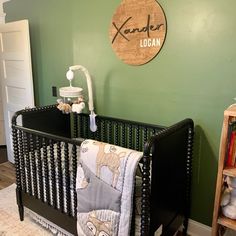 a baby crib in the corner of a room with a sign on the wall