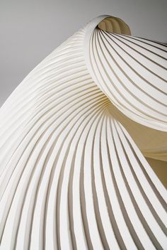 a white sculpture with wavy lines on it's sides