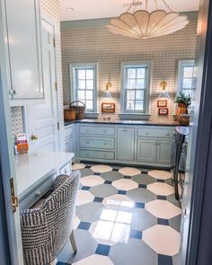 a kitchen with checkered flooring and blue cabinets