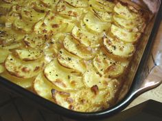 a casserole dish with potatoes and seasoning on top, ready to be eaten