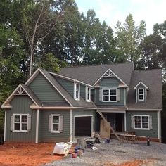 a house is being built in the middle of a wooded area with lots of trees