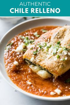 a white plate topped with food covered in sauce and garnished with parmesan cheese