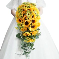 a bride holding a large bouquet of sunflowers