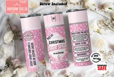 three pink christmas cheer sprays are on a bed with white flowers and the label says, straw included