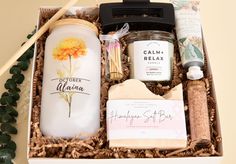 a gift box containing candles, body lotion and other personal care items in it