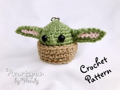 a crocheted baby yoda keychain with the words heartspun written on it