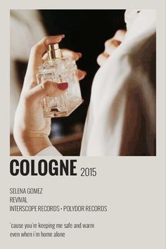 a woman holding a bottle of cologne in her hand