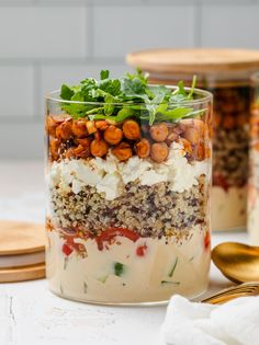 a glass jar filled with food sitting on top of a table