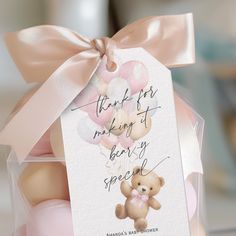 a teddy bear in a clear box with a pink ribbon and tag that says thank for making it very special