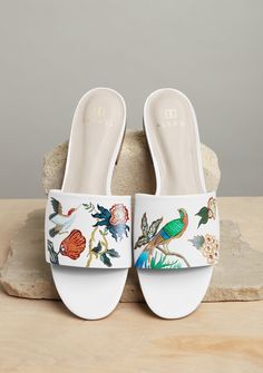 ARTISTIC NOTES Carrying on the legacy of ALEPEL’s classic bird and floral-inspired motifs integrating the essence of artistic variation and tropical culture. Shop more of our Bird Floral Collection here. PRODUCT DETAILS - One-of-a-kind. Made to order. - Slip on, open-toe slide with a 1/2 inch heel. - True to size, if you are a true half size you may size down. - 100% Genuine Nappa leather upper. - Synthetic lining and outsole. - Memory foam insole. - Water resistant surface. Wipe clean. - Consci White Slides, Tropical Bird, Bird Motif, Floral White, Comfortable Flats, 2 Inch Heels, Flora And Fauna, Leather Slides, Casual Fall Outfits