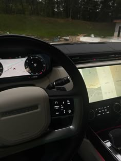 the dashboard of a car with an electronic display on it's screen and steering wheel