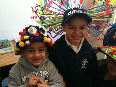 three young boys wearing hats made out of pins and magnets on their heads are smiling at the camera