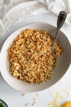 a white bowl filled with rice on top of a table