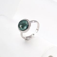 This delicate ring features stunning aquatic agate gemstones. The setting is meticulously crafted and the intricate details enhance the natural beauty of the stone, allowing its delicate hues to sparkle in the light. The adjustable strap ensures a comfortable fit, making it a versatile and elegant addition to any jewelry collection. Metal: 18K Recycled Gold Plated Vermeil on Recycled Sterling Silver,Recycled Sterling Silver Gemstone: Onyx 10mm Adjustable Ring Size: US 8 Adjustable Round Emerald Birthstone Ring, Adjustable Round Emerald Ring As Birthstone, Adjustable Round Emerald Ring With Birthstone, Adjustable Silver Turquoise Ring With Birthstone, Adjustable Opal Ring With Round Stone, Adjustable Gemstone Toe Ring, Elegant Adjustable Crystal Ring With Natural Stones, Adjustable Gemstone Rings With Round Stones, Adjustable Rings With Natural Stones