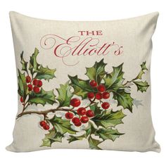 a christmas pillow with holly leaves and berries on the front, which says the allot's