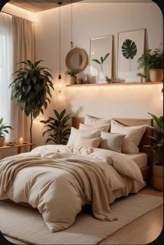 a large bed sitting in a bedroom next to a window with potted plants on it