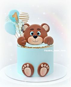 a cake with a teddy bear on top