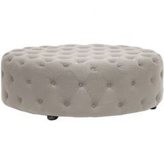 a small round ottoman with wheels and buttons on the bottom, in grey fabric upholstered