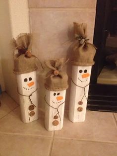 three snowmen made out of toilet paper tubes