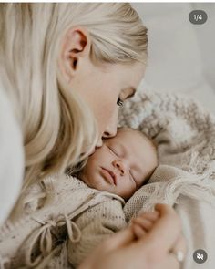 a woman holding a baby in her arms