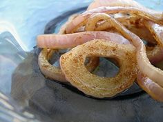 some onion rings are in a glass bowl