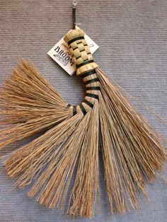 a broom is laying on the floor next to a tag