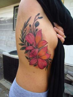 a woman with a flower tattoo on her back