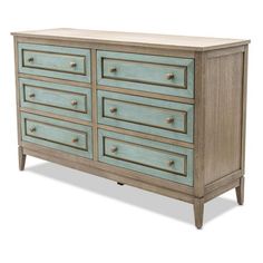 an old dresser is painted in blue and beige