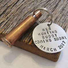 a metal keychain that says hunting buddy coming soon march 2011