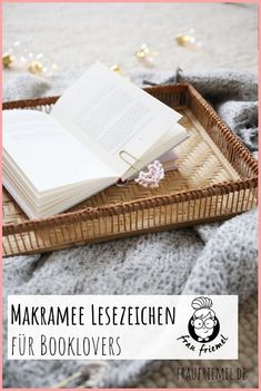 an open book sitting on top of a wicker basket