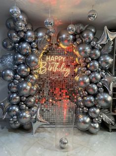 a happy birthday photo frame made out of balloons and silver balls with the words happy birthday written on it