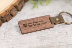 a wooden keychain with the words you have the key to my heart engraved on it