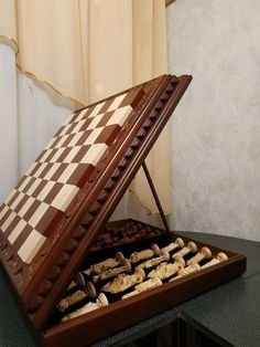 a chess board in a wooden case on a table