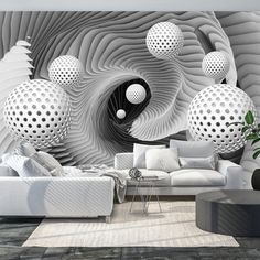 a living room filled with white furniture and lots of balls hanging from the wall above it