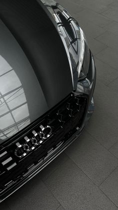 the front end of a black sports car