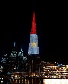 a very tall building lit up in the night sky