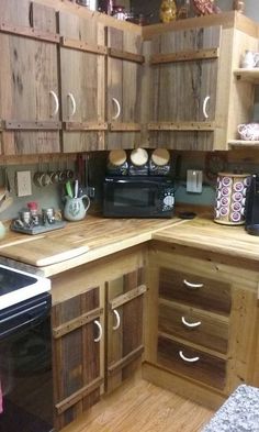 a kitchen with wooden cabinets and black appliances