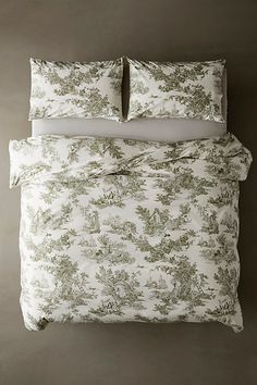 a bed with two pillows on top of it and a pillow case in the middle