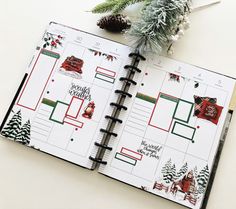 an open planner with christmas decorations on it