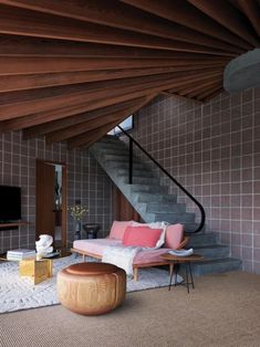 a living room filled with furniture and a stair case