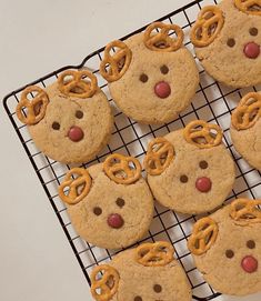 cookies with pretzels and reindeer noses are on a cooling rack, ready to be eaten