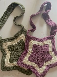 two crocheted purses sitting next to each other