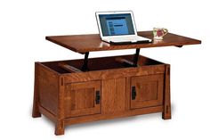 an open laptop computer sitting on top of a wooden coffee table with drawers underneath it