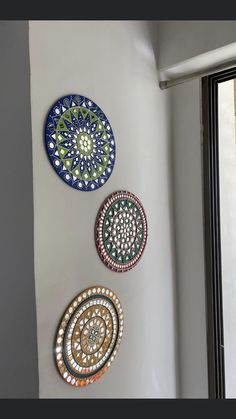 three decorative plates hanging on the wall