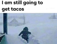 a person is walking through the snow in front of a building with words on it