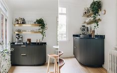 two pictures of the same kitchen and dining room with plants on the shelves above the bar